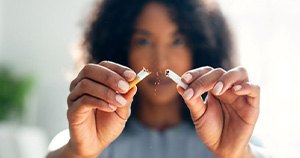 Woman breaking a cigarette in half