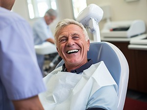 Happy older man in dental treatment chair