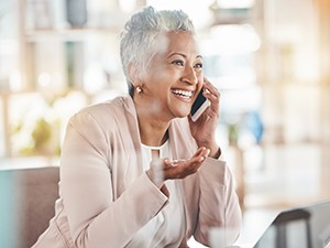 Happy older woman talking on phone