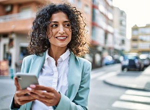 Confident woman in business attire standing outdoors