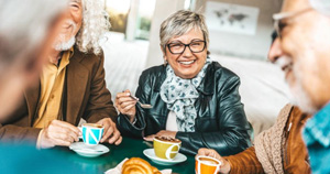 Senior friends eating a meal together