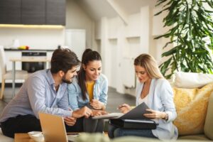 Insurance agent talking to young couple about their coverage